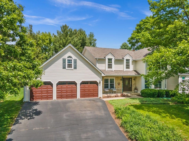 5N647 Forest Glen Ln, Saint Charles, IL 60175 - traditional home with covered porch, asphalt driveway, a front yard, a shingled roof, and an attached garage