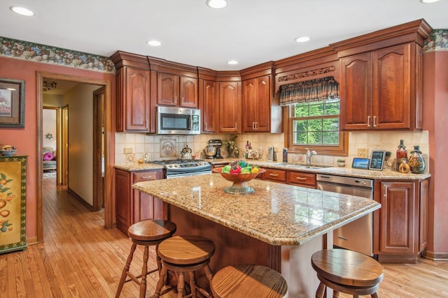 5N647 Forest Glen Ln, Saint Charles, IL 60175 - kitchen with stainless steel appliances, light wood-style floors, a kitchen breakfast bar, and recessed lighting