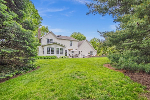 5N647 Forest Glen Ln, Saint Charles, IL 60175 - rear view of house featuring a chimney, a lawn, and a patio