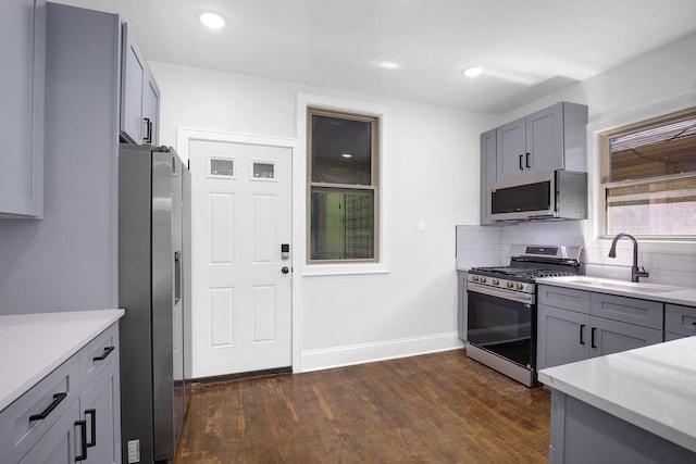 1724 W 105th St, Chicago, IL 60643 - kitchen featuring appliances with stainless steel finishes, dark wood-type flooring, gray cabinets, decorative backsplash, and recessed lighting