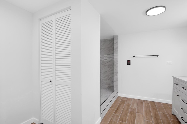 1724 W 105th St, Chicago, IL 60643 - bathroom with a closet, tiled shower, vanity, baseboards, and wood tiled floors