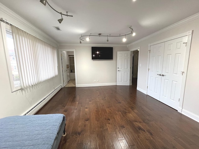 6632 W 95th St Unit 2C, Oak Lawn, IL 60453 - unfurnished bedroom featuring baseboard heating, rail lighting, ornamental molding, wood finished floors, and baseboards