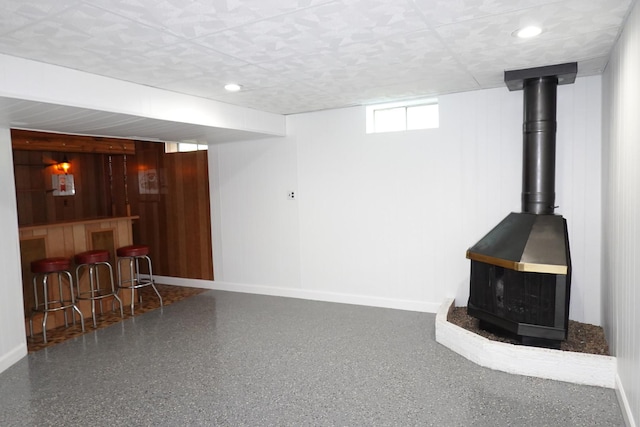 1330 Ridgeway Ave, Round Lake Beach, IL 60073 - below grade area with a wood stove, baseboards, a bar, recessed lighting, and wood walls