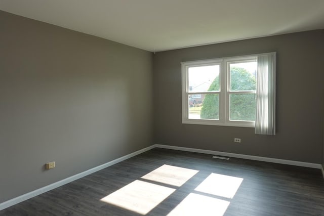 1330 Ridgeway Ave, Round Lake Beach, IL 60073 - spare room featuring dark wood-style flooring and baseboards