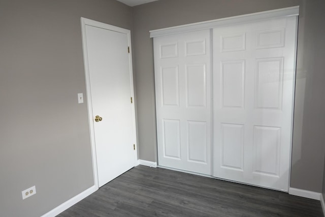 1330 Ridgeway Ave, Round Lake Beach, IL 60073 - unfurnished bedroom with dark wood-style flooring, a closet, and baseboards