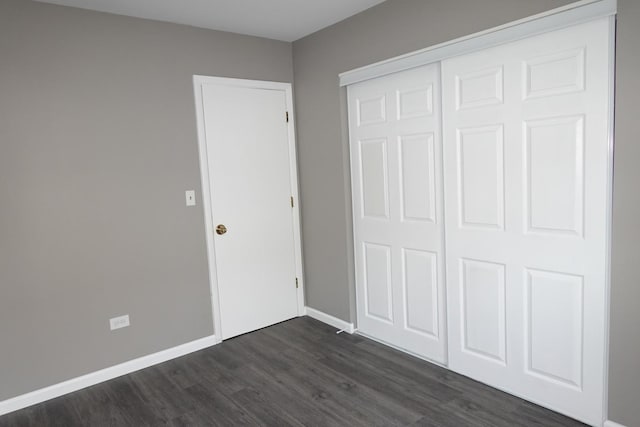 1330 Ridgeway Ave, Round Lake Beach, IL 60073 - unfurnished bedroom featuring dark wood-type flooring, a closet, and baseboards