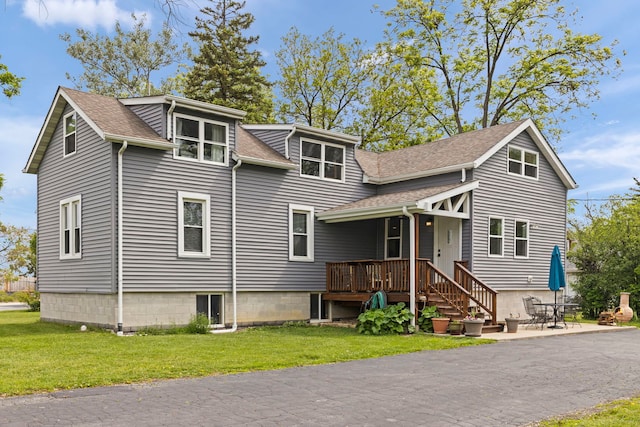 17811 Harwood Ave, Homewood, IL 60430 - view of front of home featuring a shingled roof, a front yard, and a patio area