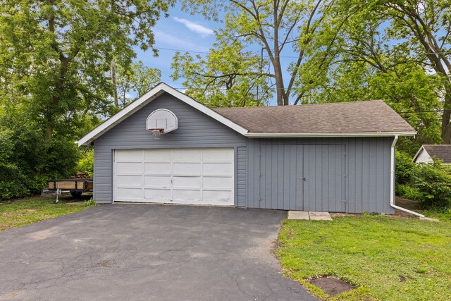 17811 Harwood Ave, Homewood, IL 60430 - view of front of home with an outbuilding, a front yard, a shingled roof, and asphalt driveway