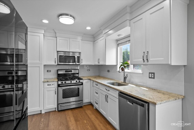 2724 Bluewater Cir, Naperville, IL 60564 - kitchen with stainless steel appliances, a sink, white cabinetry, dark wood-style flooring, and light stone countertops