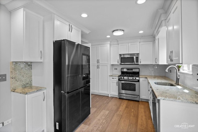 2724 Bluewater Cir, Naperville, IL 60564 - kitchen featuring stainless steel appliances, a sink, white cabinets, light wood-type flooring, and recessed lighting