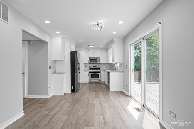 2724 Bluewater Cir, Naperville, IL 60564 - kitchen with stainless steel appliances, light wood-style floors, light countertops, white cabinets, and recessed lighting