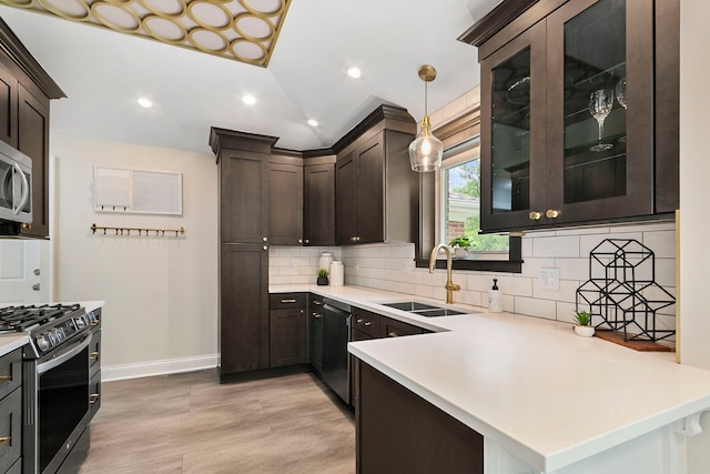 1717 Dundee Rd, Northbrook, IL 60062 - kitchen with a sink, appliances with stainless steel finishes, backsplash, dark brown cabinetry, and baseboards