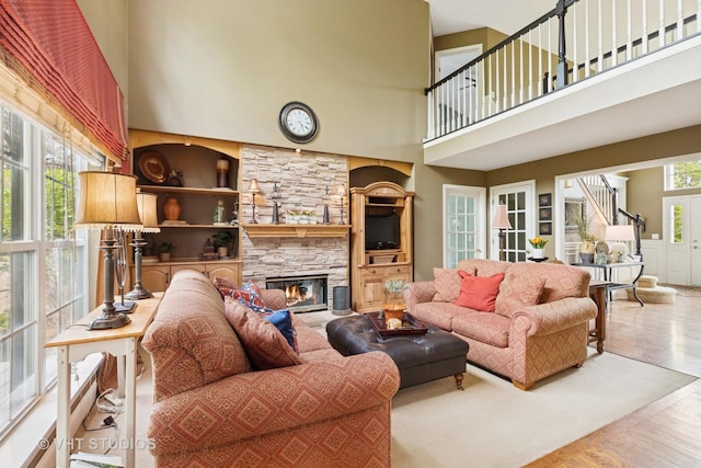 36932 N Fernview Ln, Lake Villa, IL 60046 - living room featuring a towering ceiling, a stone fireplace, and wood finished floors
