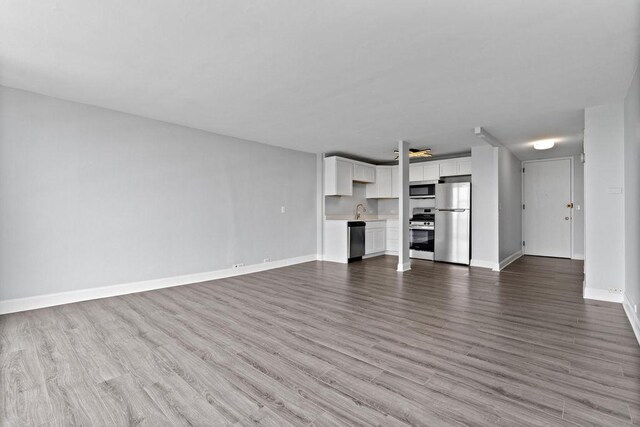 2901 S Michigan Ave Unit 903, Chicago, IL 60616 - unfurnished living room featuring a sink, wood finished floors, and baseboards