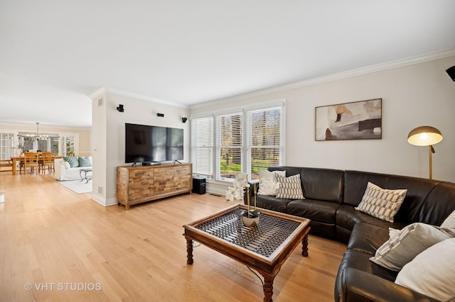 630 Juniper Rd, Glenview, IL 60025 - living room featuring crown molding, a chandelier, plenty of natural light, light wood-style flooring, and baseboards
