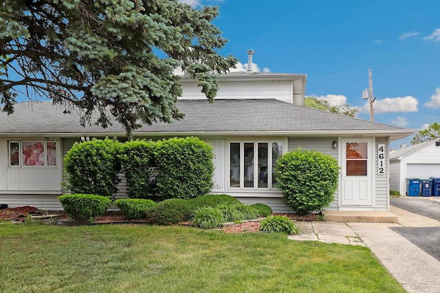 4612 W 89th Pl, Hometown, IL 60456 - view of front of property featuring a front lawn, a shingled roof, and board and batten siding