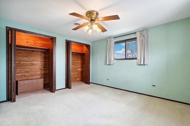 4612 W 89th Pl, Hometown, IL 60456 - unfurnished bedroom featuring carpet flooring, ceiling fan, two closets, wood walls, and baseboards