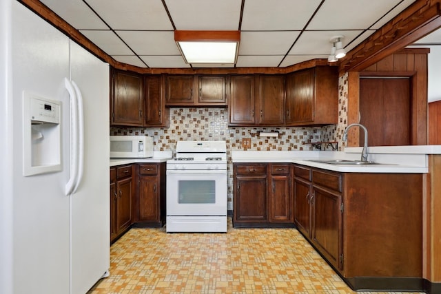 4612 W 89th Pl, Hometown, IL 60456 - kitchen featuring white appliances, a sink, light countertops, backsplash, and a drop ceiling
