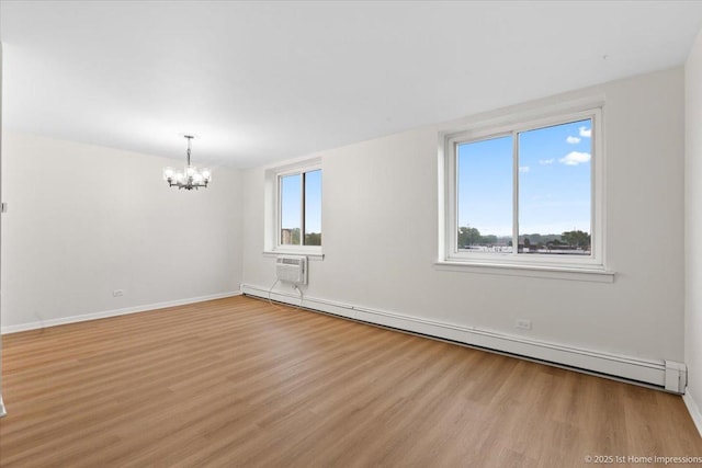 9745 S Karlov Ave Unit 608, Oak Lawn, IL 60453 - spare room with a baseboard radiator, a chandelier, light wood-style flooring, baseboards, and a wall unit AC