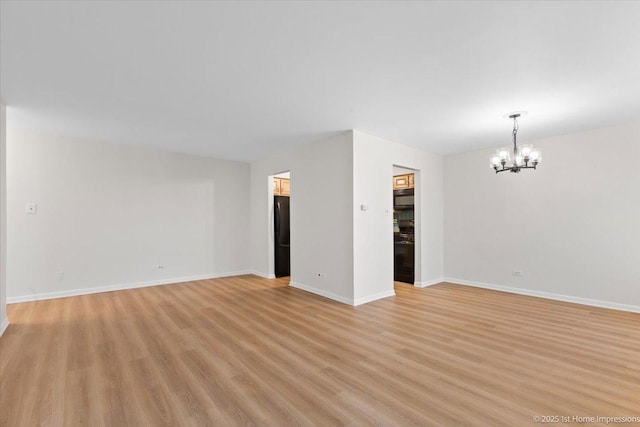 9745 S Karlov Ave Unit 608, Oak Lawn, IL 60453 - spare room featuring a chandelier, light wood-style floors, and baseboards