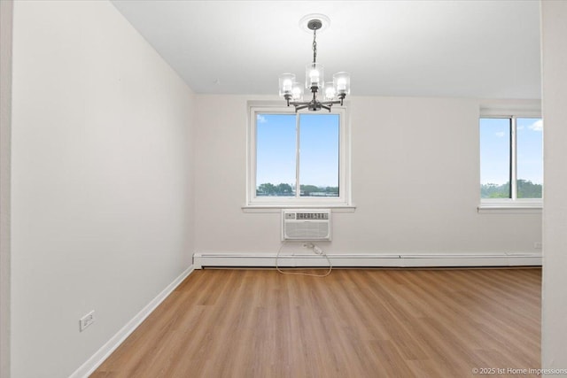 9745 S Karlov Ave Unit 608, Oak Lawn, IL 60453 - spare room with a wall mounted AC, a chandelier, light wood finished floors, baseboards, and a baseboard radiator