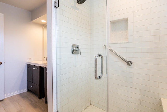 125 Boardwalk Pl Unit 101, Park Ridge, IL 60068 - full bath featuring a shower stall, vanity, wood finished floors, and baseboards