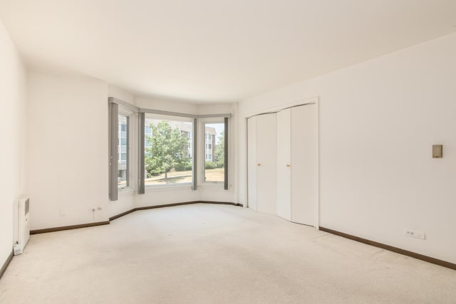 401 Ascot Dr Unit 1C, Park Ridge, IL 60068 - unfurnished bedroom with carpet flooring, radiator heating unit, and a closet