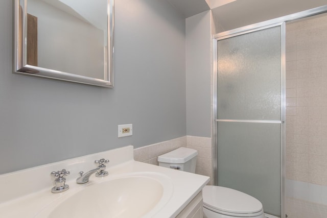 401 Ascot Dr Unit 1C, Park Ridge, IL 60068 - bathroom featuring a stall shower, tile walls, vanity, and a wainscoted wall