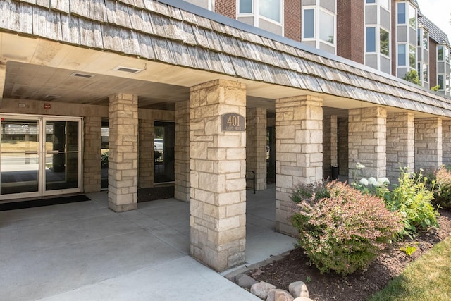 401 Ascot Dr Unit 1C, Park Ridge, IL 60068 - view of exterior entry with stone siding and mansard roof