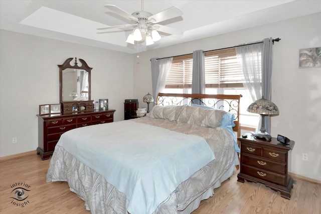 1360 Pheasant Chase Cir, Beecher, IL 60401 - bedroom with light wood-style flooring, baseboards, a ceiling fan, and a tray ceiling