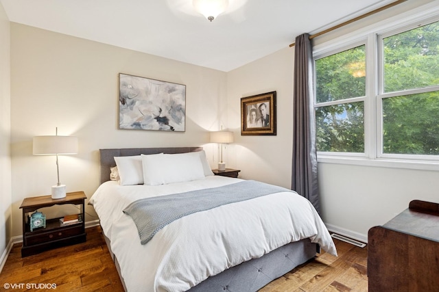 5844 N Hermitage Ave Unit A, Chicago, IL 60660 - bedroom with multiple windows, wood finished floors, and baseboards