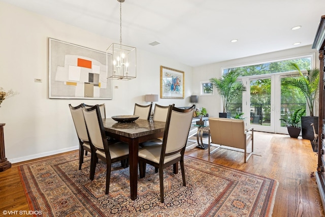 5844 N Hermitage Ave Unit A, Chicago, IL 60660 - dining area featuring wood finished floors, a chandelier, french doors, and baseboards