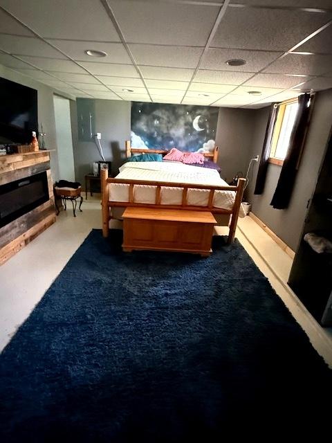 29478 E County Road 2390th Rd, Manito, IL 61546 - carpeted bedroom with a paneled ceiling and a glass covered fireplace