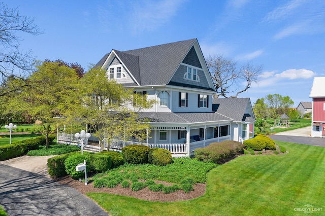 3838 Plainfield Rd, Oswego, IL 60543 - victorian home featuring covered porch, a front yard, and roof with shingles