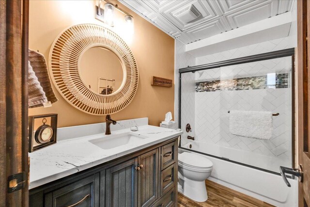 3838 Plainfield Rd, Oswego, IL 60543 - bathroom featuring toilet, vanity, bath / shower combo with glass door, wood finished floors, and an ornate ceiling