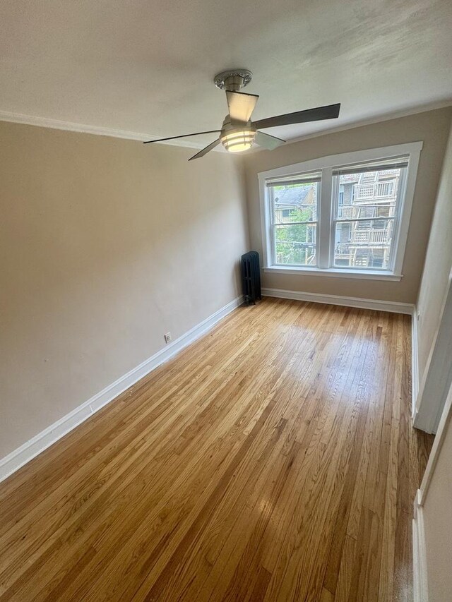 6638 S Greenwood Ave Unit 2B, Chicago, IL 60637 - spare room with baseboards, light wood-style flooring, a ceiling fan, and radiator