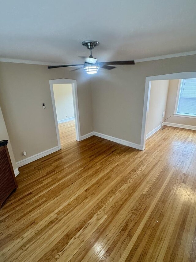 6638 S Greenwood Ave Unit 2B, Chicago, IL 60637 - empty room featuring crown molding, light wood-style floors, baseboards, and ceiling fan