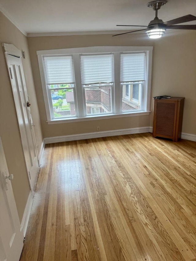 6638 S Greenwood Ave Unit 2B, Chicago, IL 60637 - unfurnished room with light wood finished floors, crown molding, a ceiling fan, and baseboards