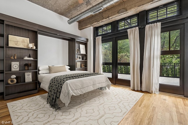 1070 W 15th St Unit 147, Chicago, IL 60608 - bedroom with access to exterior, wood finished floors, and a towering ceiling