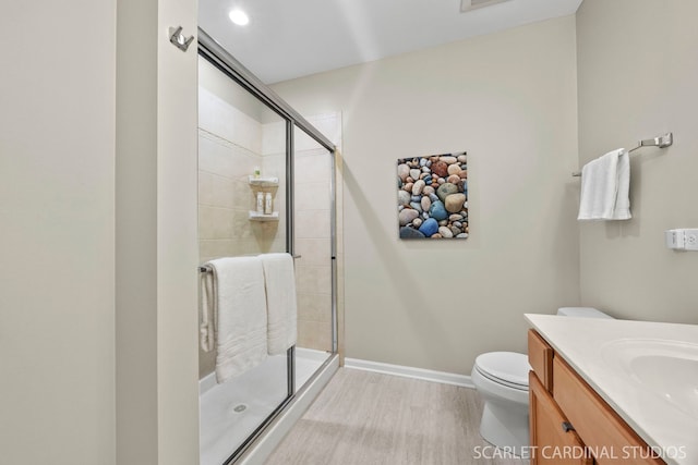 14 S Prospect St Unit 211, Roselle, IL 60172 - bathroom featuring a stall shower, toilet, vanity, baseboards, and wood finished floors