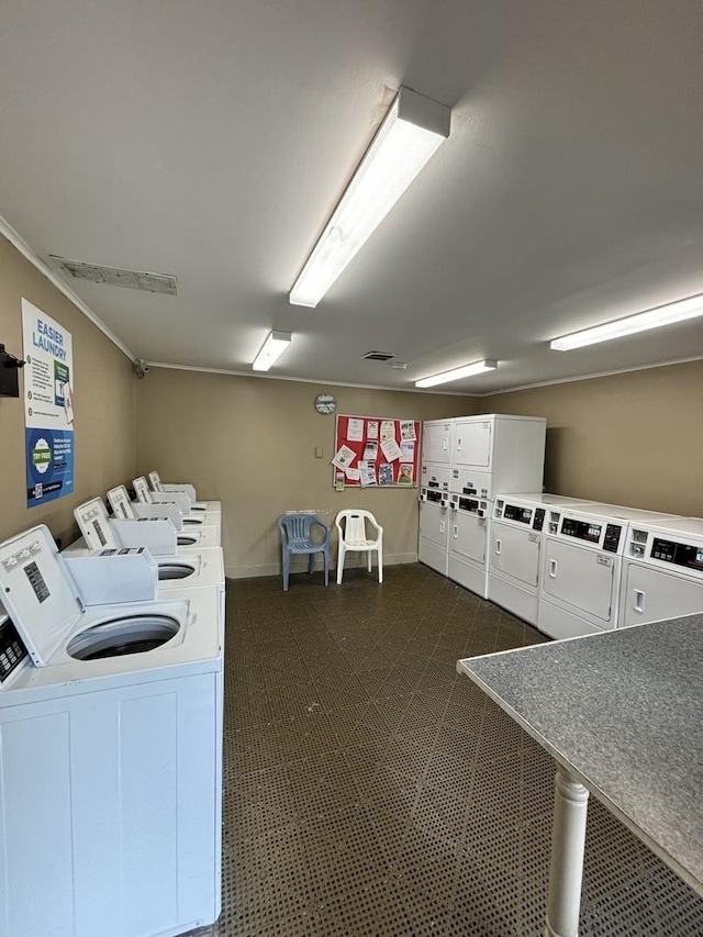 59 Vail Colony St Unit 3, Fox Lake, IL 60020 - shared laundry room featuring independent washer and dryer, baseboards, and crown molding