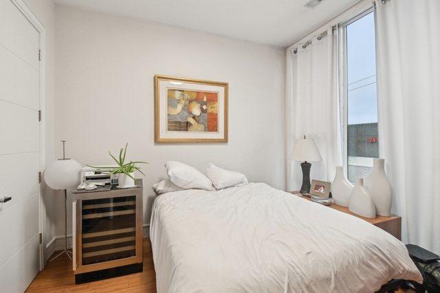 2424 W Chicago Ave Unit 202, Chicago, IL 60622 - bedroom featuring beverage cooler and light wood-type flooring