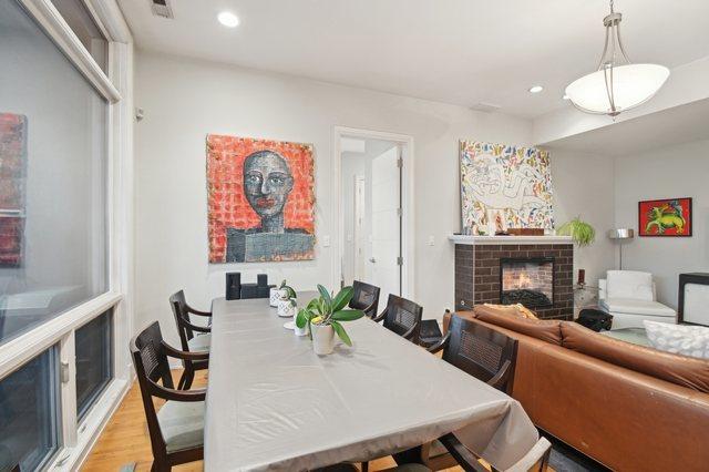 2424 W Chicago Ave Unit 202, Chicago, IL 60622 - dining space with a fireplace, recessed lighting, and wood finished floors
