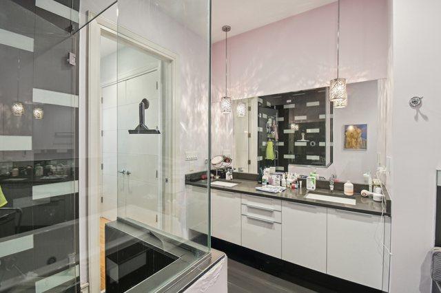 2424 W Chicago Ave Unit 202, Chicago, IL 60622 - bathroom with double vanity and a shower with door