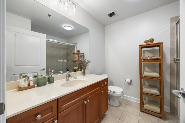 1400 S Michigan Ave Unit 707, Chicago, IL 60605 - bathroom featuring vanity, toilet, a shower stall, tile patterned flooring, and baseboards