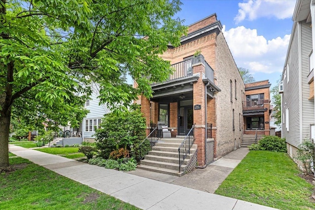 2158 W Giddings St Unit 1, Chicago, IL 60625 - view of front of home featuring a balcony, brick siding, and a front yard