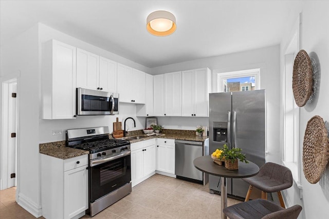 2158 W Giddings St Unit 1, Chicago, IL 60625 - kitchen with stainless steel appliances, a sink, white cabinetry, and dark stone countertops