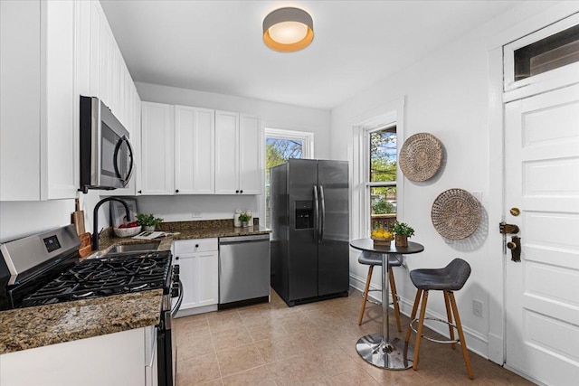 2158 W Giddings St Unit 1, Chicago, IL 60625 - kitchen featuring stainless steel appliances, a sink, and white cabinetry