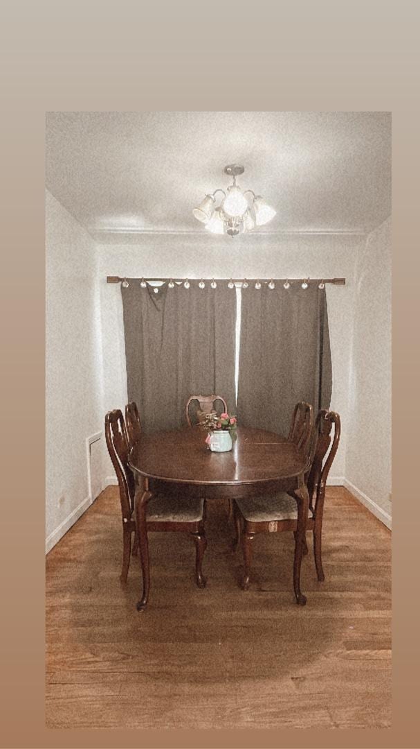 11138 Shaw St, Westchester, IL 60154 - dining space featuring baseboards, a chandelier, and wood finished floors