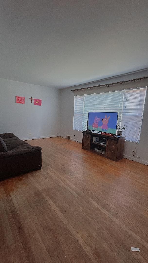 11138 Shaw St, Westchester, IL 60154 - unfurnished living room with wood finished floors